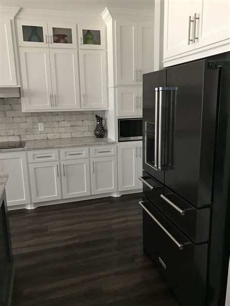 black stainless steel appliances with white kitchen cabinets|white cabinets with black appliances.